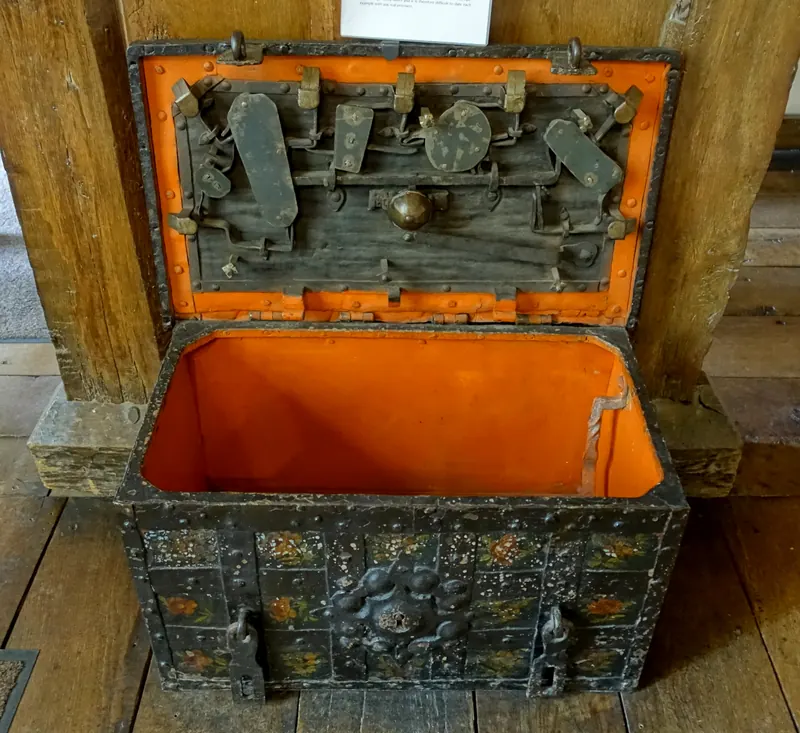 An open seventeenth-century German wrought-iron strongbox with its lock mechanism inside the lid